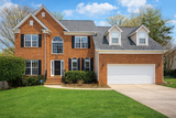 Sunny suburban home with lush lawn
